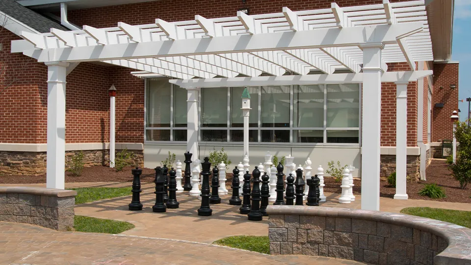 A fiberglass pergola shading the exterior of a library.