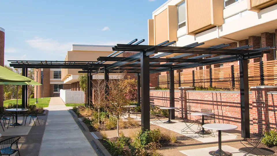 A custom aluminum pergola shading an outdoor space at Penn State University.